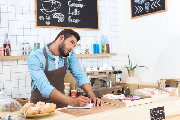 Cafe owner taking notes — Stock Photo, Image