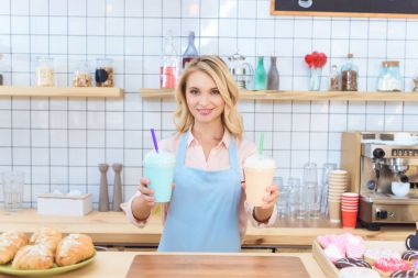 Garson holding milkshakes