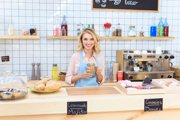 waitress holding jar with lemonade