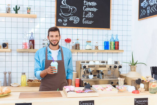 barista holding latte 