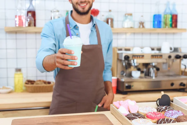 barista holding latte 