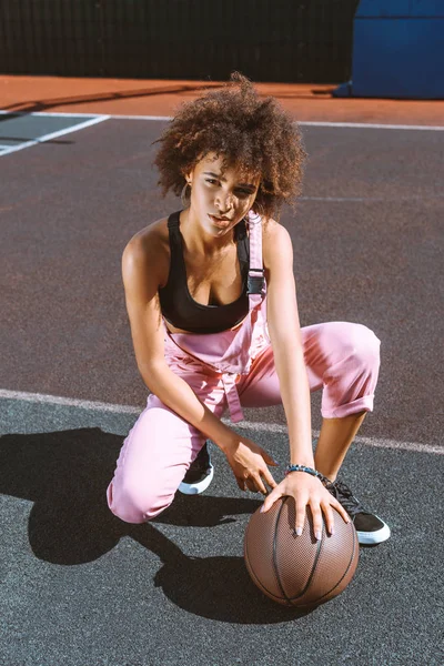 Афроамериканська жінка з баскетболом на спортивному майданчику — стокове фото