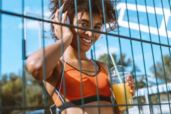 Mujer afroamericana escuchando música en auriculares — Foto de Stock