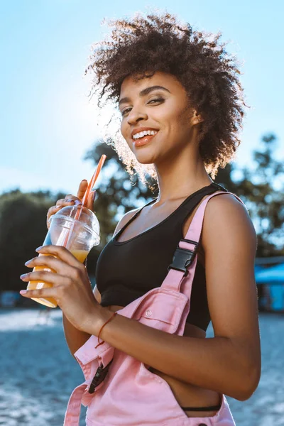 African-american woman drinking juice — Stock Photo, Image