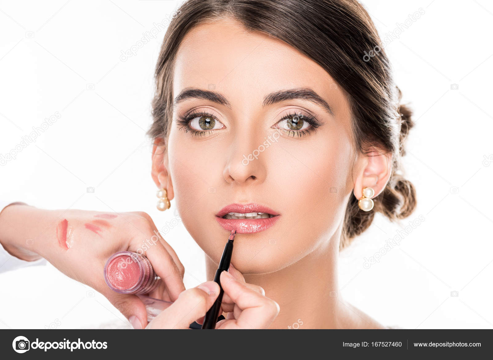 Makeup artist applying lipstick on model Stock Photo by ©IgorVetushko