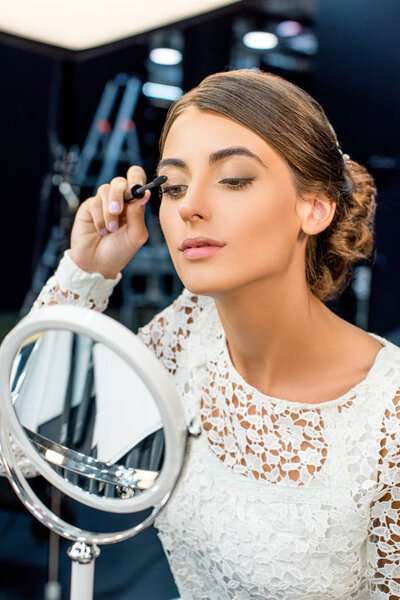 woman applying mascara