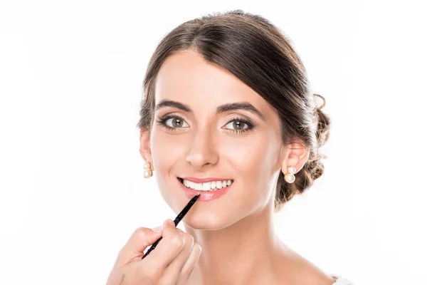 Makeup artist applying lipstick on model — Stock Photo, Image