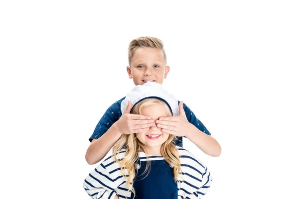 Boy closing eyes of sister — Stock Photo, Image