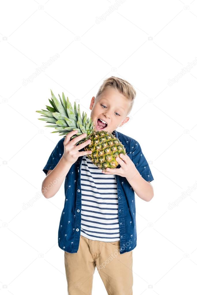 boy biting pineapple 