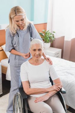 nurse and senior woman in wheelchair clipart