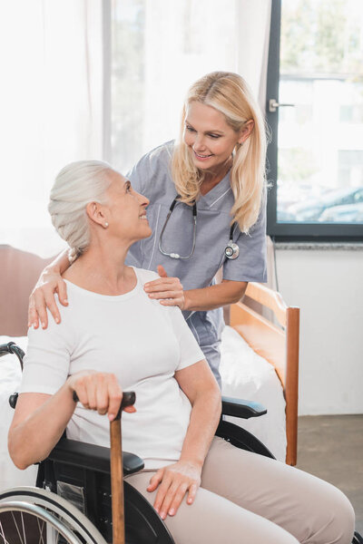 nurse and senior woman in wheelchair