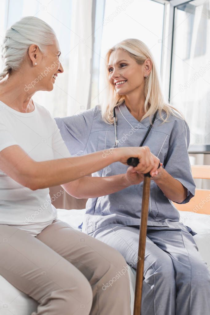 nurse and senior woman with cane