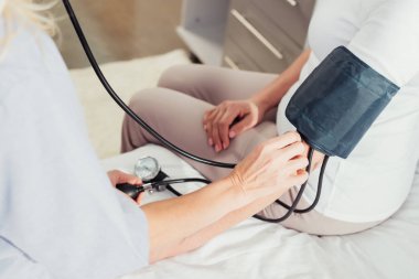 nurse measuring blood pressure to patient