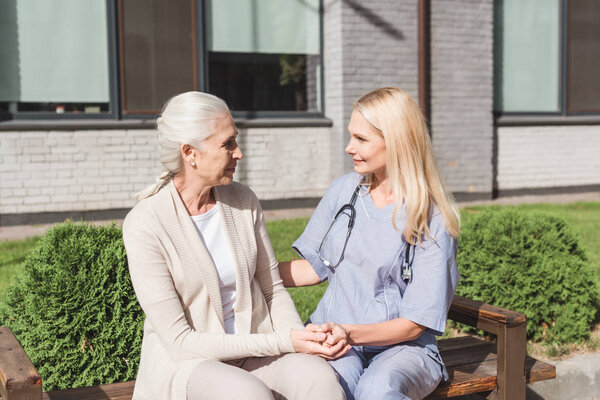 nurse and patient holding hands