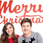 Couple with merry christmas lettering