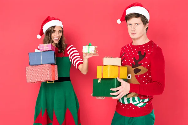 Casal em chapéus de santa com presentes — Fotografia de Stock