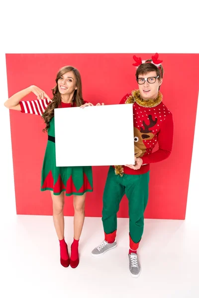 Couple in christmas costumes with banner — Stock Photo, Image