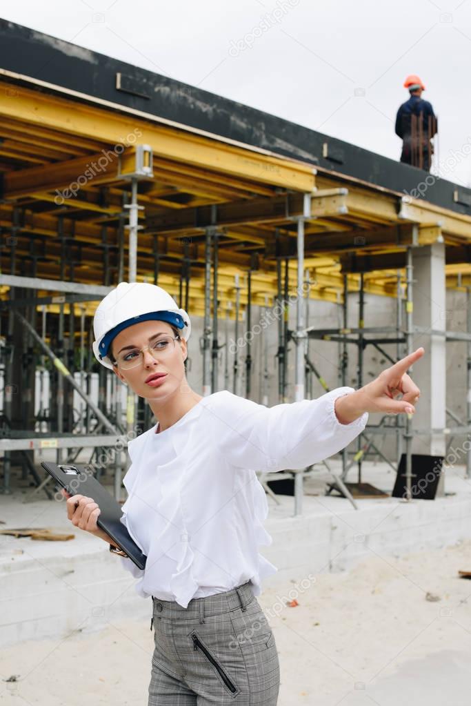 engineer pointing at construction site