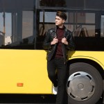 Man standing near city bus
