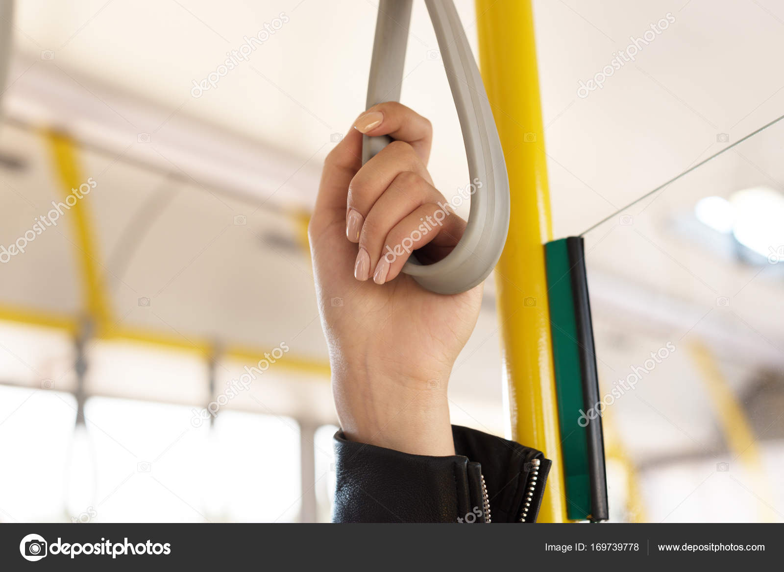 Woman holding bus handle — Stock Photo © IgorVetushko 169739778