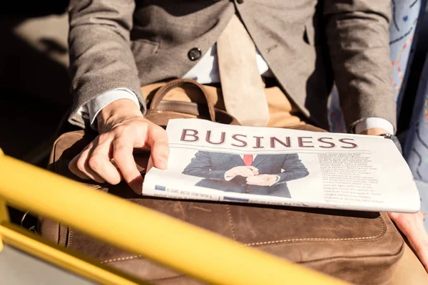 Man with newspaper in bus — Stock Photo, Image