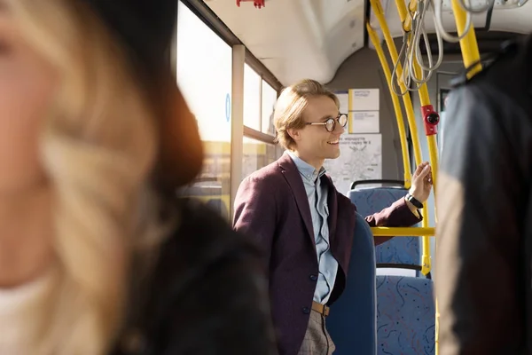 Man in eyeglasses riding in city bus — Stock Photo, Image