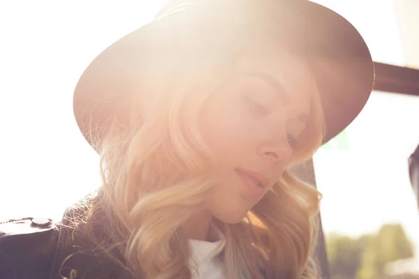 Thoughtful woman in black hat — Stock Photo, Image