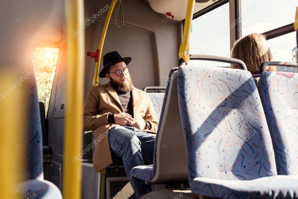 man riding in public transport 