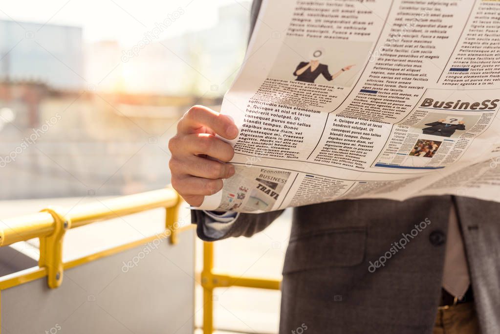 man with newspaper in bus