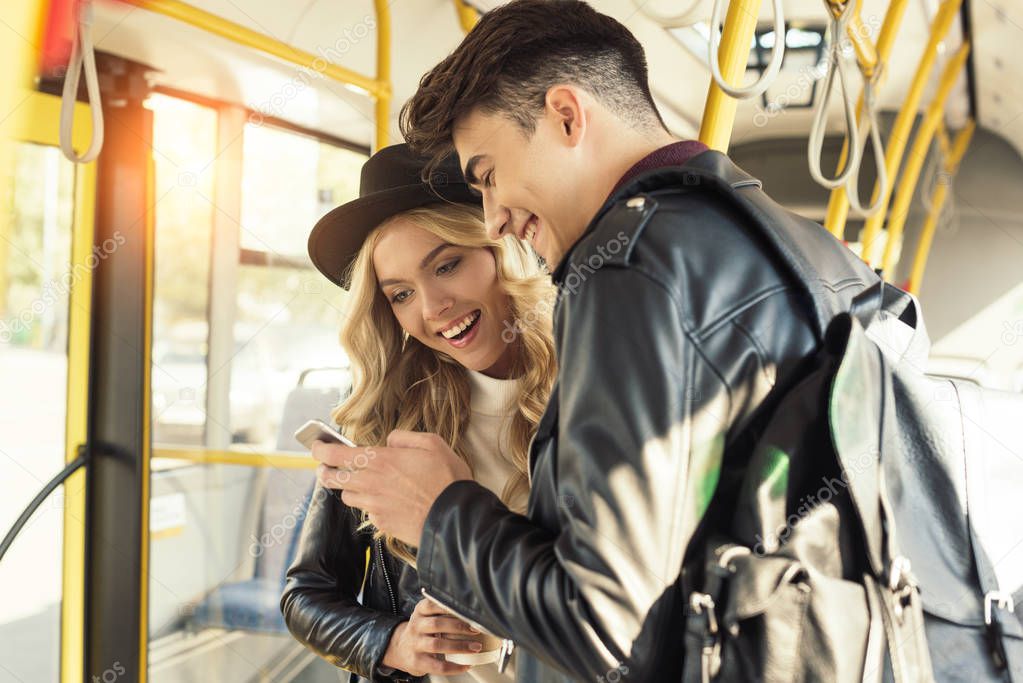 couple with smartphone in public transport