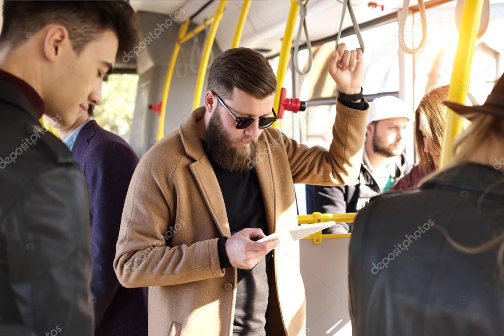 man using tablet in bus