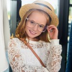 Stylish child in eyeglasses and straw hat