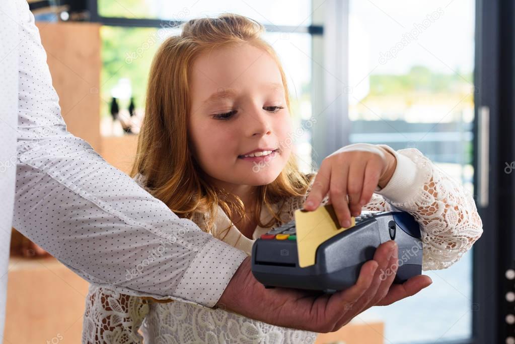 child paying with credit card