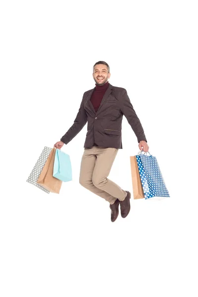 Hombre saltando con bolsas de compras — Foto de Stock