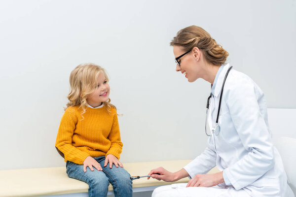 doctor doing neurology examination for girl