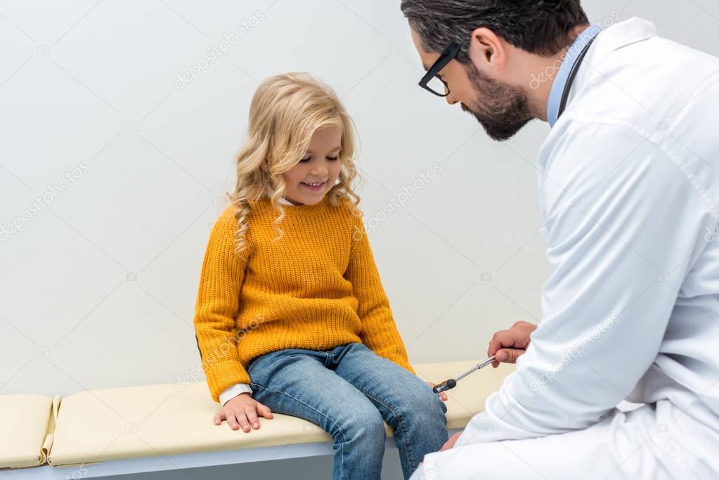 pediatrist making neurology examination for girl
