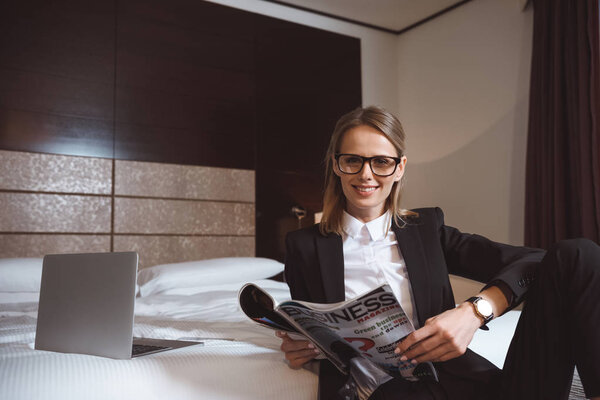 business woman reading magazine in hotel
