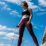 Woman on rock with jumping rope