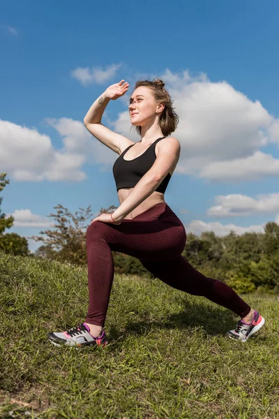 Woman stretching legs — Free Stock Photo
