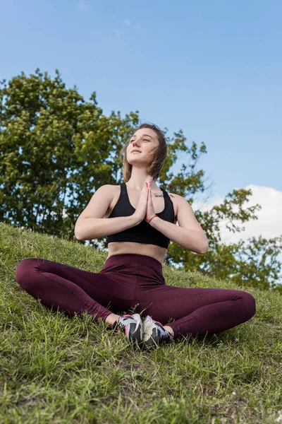 Woman sitting in bound angle pose — Free Stock Photo