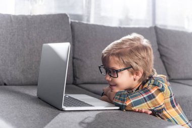 little boy looking at laptop clipart