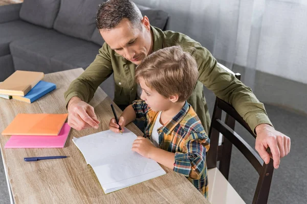 Vader en zoon die huiswerk maken — Stockfoto