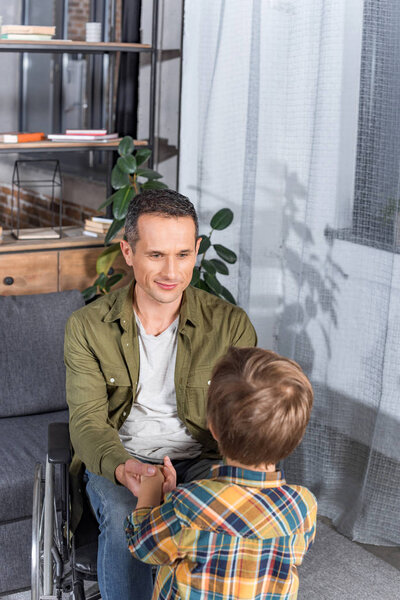 father in wheelchair and son