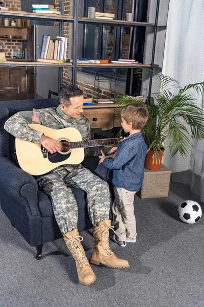 Uomo che suona la chitarra per il figlio — Foto Stock