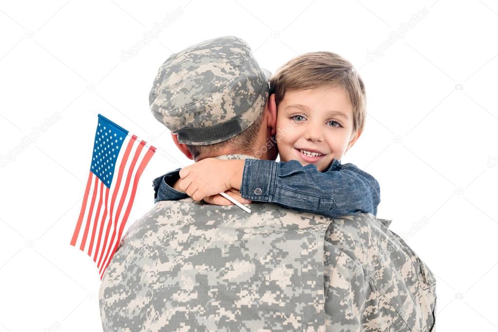 father in military uniform embracing with son