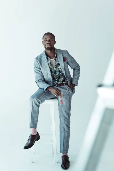 Fashionable african american man on bar stool — Stock Photo, Image