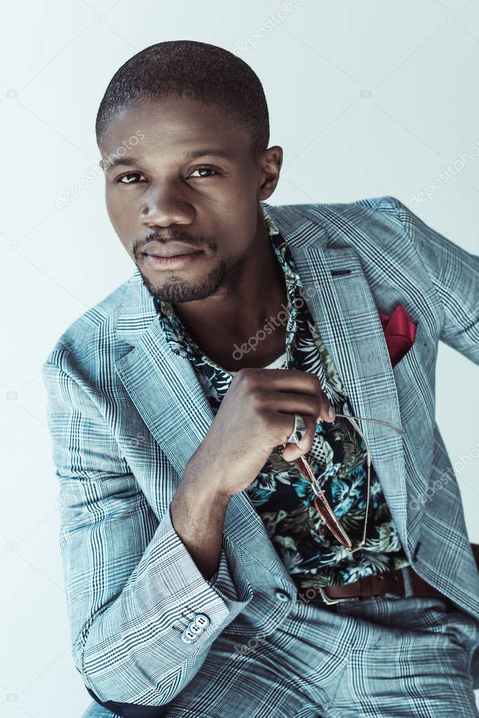 african american man holding glasses