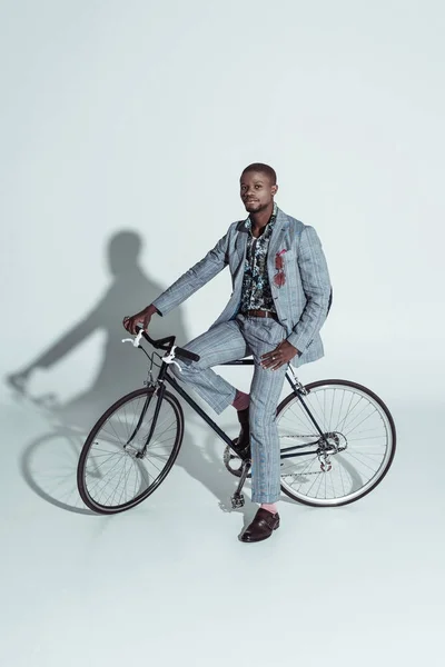 Fashionable man posing on bicycle — Stock Photo, Image