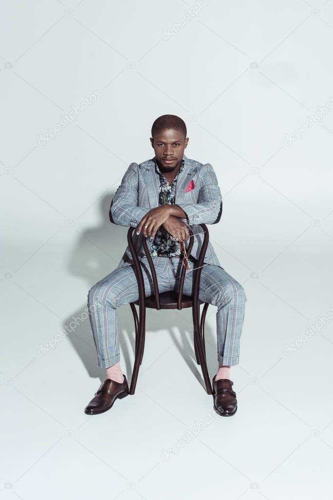 african american man on chair backwards