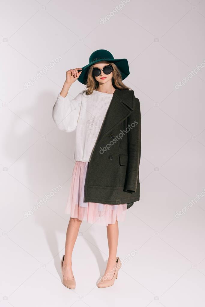 teenage girl in hat and overcoat